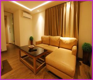 a living room with a couch and a coffee table at PRIME LOCATION NEAR SEA BEACH HOTEL NILADREE WAVES! Puri - Near Jagannath Temple and Golden Beach- Swargadwar Beach - Bengali Market - A Top Rated Hotel IN PURI in Puri