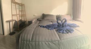 a bed with blue towels on it in a bedroom at Lipe Baan Talay Homestay in Ko Lipe