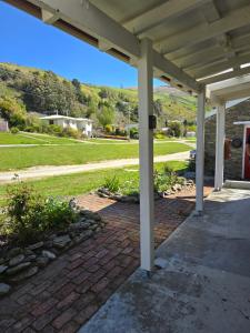 a porch of a house with a white roof at Dalton's Deed in Roxburgh