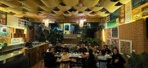 a group of people sitting at a table in a restaurant at Chillin' House in Cat Ba +59 photos