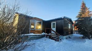 a tiny house in the snow in the yard at The Bear Road in Churchill