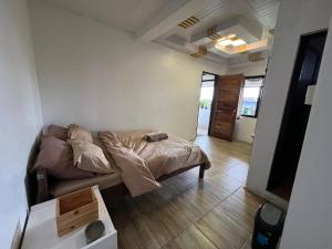 a bedroom with a bed and a living room at Andrew & Mary's Lodging House in Sagada
