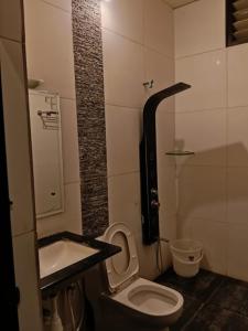 een kleine badkamer met toilet en wastafel bij Nijaguna Resorts in Chāmrājnagar