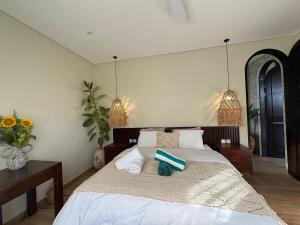 a bedroom with a large bed with towels on it at Villa Shugo Tenshi in Badung +30 photos
