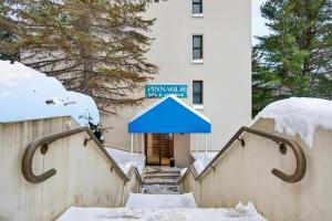 a building with a blue sign in the snow at Pinnacle E15 in Killington