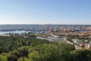 a view of a city with a river and buildings at Elegant Apartment with Parking Space and Balcony by Noclegi Renters in Gdynia