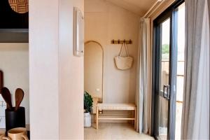 a living room with a chair and a window at Ocean Sounds - Where Style Meets Nature in Mapua +16 photos