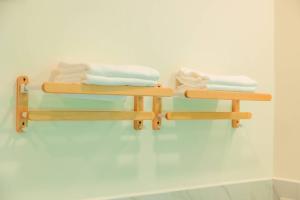 two wooden towel racks on a wall with towels at Yugen House - Yutaka in Nong Prue +4 photos