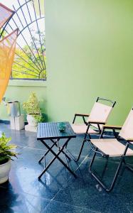 two chairs and a table in a room at Chiri Homestay in Thôn Trường Giang