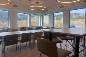 a conference room with a table and chairs and windows at La Quinta Inn & Suites by Wyndham Kelowna BC in Kelowna