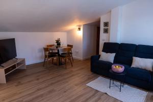 a living room with a blue couch and a table at La Terraza Guadalest in El Castell de Guadalest