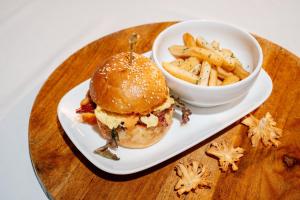 a plate with a sandwich and a bowl of fries at SHANKEE Sudirman in Jakarta