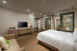 a bedroom with a large white bed and a desk at Dong Xuan Boutique Hotel in Hanoi