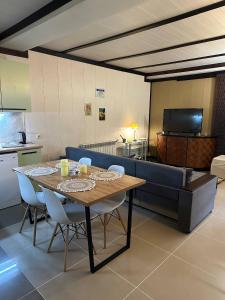 a dining room with a table and a couch at Leonovs in Almaty +56 photos