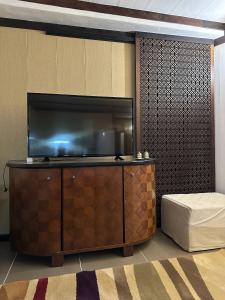 a room with a flat screen tv on a wall at Leonovs in Almaty