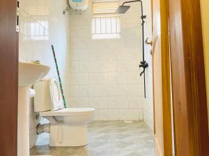 a bathroom with a toilet and a sink at Zuri stays in Kampala