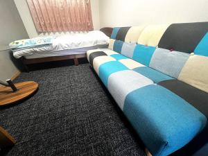 a living room with a couch and a bed at Dream Village Kitakami in Kitakami