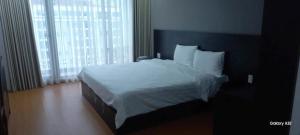 ein Schlafzimmer mit einem großen Bett mit weißen Laken und Kissen in der Unterkunft HN Hotel Bắc Ninh in Bắc Ninh