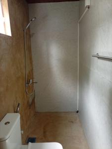 a bathroom with a shower and a toilet at Airport Transit Motel in Katunayaka