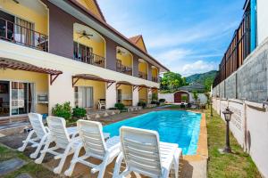 an image of a house with a swimming pool at Chernin Apartment Suites, Rawai in Ban Saiyuan (1)