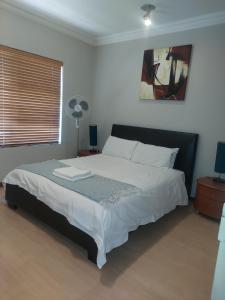 En eller flere senge i et værelse på Premium Getaway @ la Bella Costa