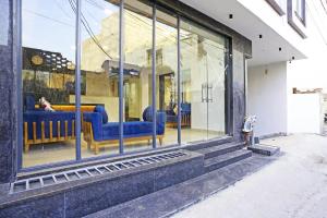 a store front with blue furniture in a window at Hotel Vivanta Residency Delhi Airport in New Delhi