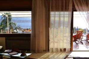 a living room with a large window with a view of the ocean at Sicily in Villa in Messina