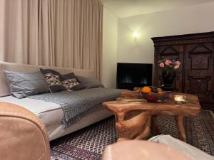 a living room with a couch and a table at Apartment Chalet Ambros in Lech am Arlberg