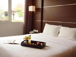 bandeja de fruta en una cama en una habitación de hotel en D'Season Premiere Hotel, en Kesembu 97 fotos más