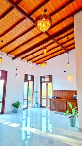 a large living room with a wooden ceiling at Mangrove Inn Mirissa in Kamburugamuwa