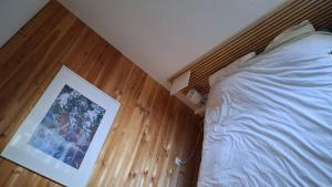 a bedroom with a bed and a picture on the floor at Les Isards Pied des pistes in Ax-les-Thermes