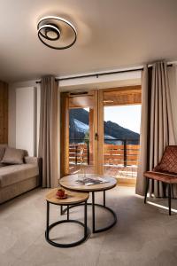 a living room with a table and a couch at Chalet Valora in Le Grand-Bornand