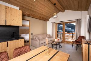 a living room with a couch and a table at Chalet Valora in Le Grand-Bornand