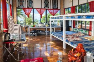 a bedroom with two bunk beds and a table at Vườn Dừa Cam Bình 1 in Lagi