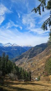 a view of a mountain valley with snow capped mountains at Hill Ice Guesthouse in Tosh