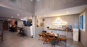 a kitchen and dining room with a table and chairs at Hoppers Place Donmuang Hostel in Bangkok