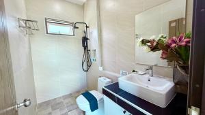 a white bathroom with a sink and a toilet at Legacy pool villa in Ban Chong Phli +17 photos