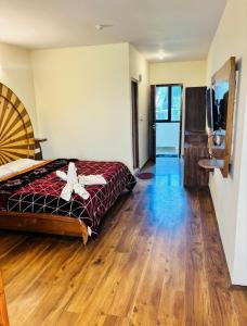 a bedroom with a bed with a cross on it at Cedar Valley Retreat in Jagatsukh