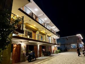 a motorcycle parked in front of a building at night at Cedar Valley Retreat in Jagatsukh
