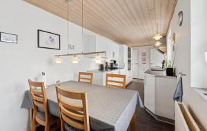 a kitchen and dining room with a table and chairs at Nice Home In Thyborøn With Wifi in Thyborøn
