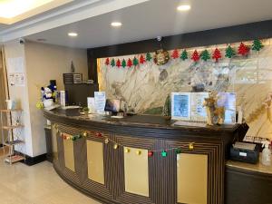 an office counter with christmas decorations on the wall at Hub Hotel - Zhongshan Branch in Taipei