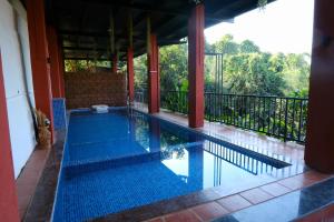 a swimming pool in the middle of a house at The SKYi County Dapoli in Dapoli