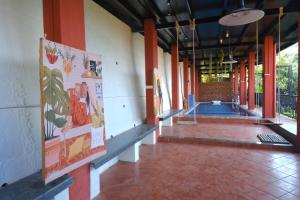 a hallway of a building with paintings on the walls at The SKYi County Dapoli in Dapoli