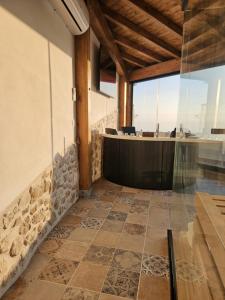 a lobby with a reception desk and a tile floor at La Nuit d'Amélie 2 in Norma