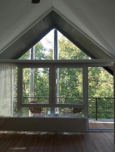 a large window in a living room with trees at NEU! Ferienwohnung Bottelterberg in Saarburg