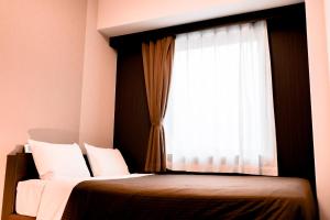 En eller flere senge i et værelse på Arigato Stay Kanazawa Ekimae