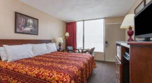 una habitación de hotel con una cama y una ventana grande en Ramada Limited Norfolk, en Greenwich 34 fotos más