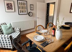 a dining room with a wooden table and chairs at The Linden Lodge, near Cathedral, free parking in Lincoln