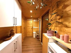 een keuken met witte kasten en houten wanden bij Ubytování Na pasece in Benešov