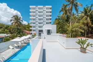 an exterior view of a resort with a swimming pool at The Up Hotel Phu Quoc Island - The Poolside Escape in Phu Quoc